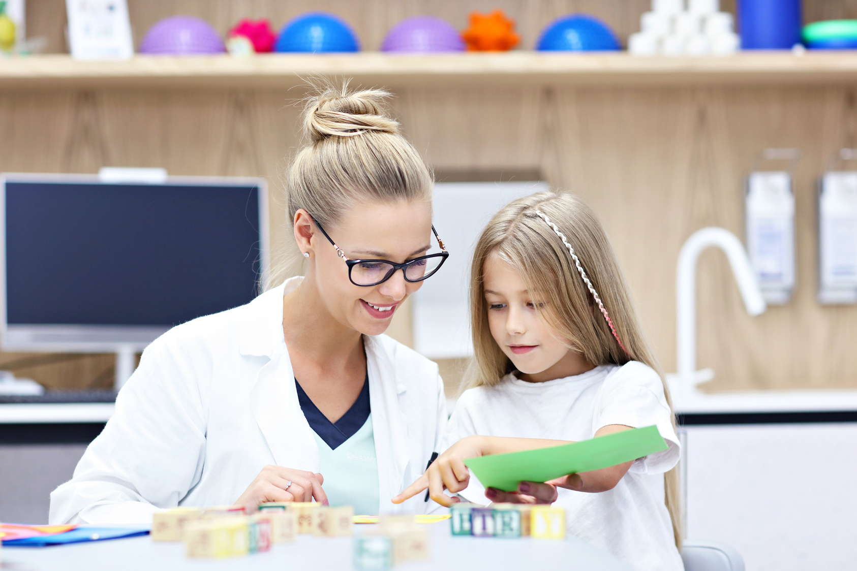 Child Psychologist Working with Young Girl in Office